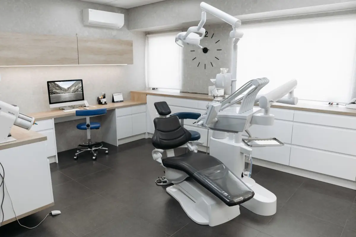 A modern dental treatment room with a chair and equipment